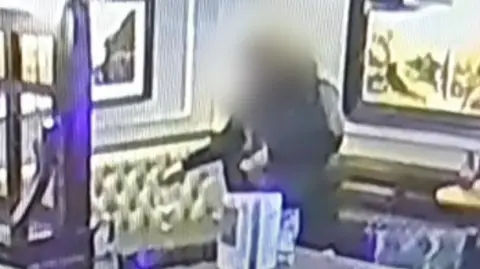 CCTV footage of a man spiking women's drinks in a pub.