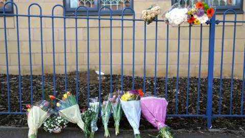 Flowers laid at the scene on Ilkeston Road in Nottingham where Grace O'Malley-Kumar and Barnaby Webber were stabbed to death