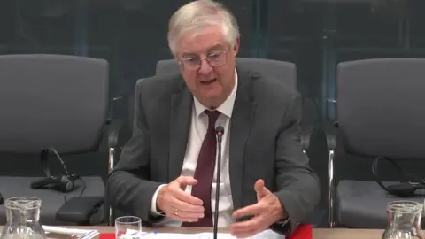 Senedd Cymru Mark Drakeford appearing before the Senedd's Finance Committee