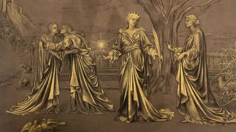 Trustees of the De Morgan Foundation A painting with brown and bronze colours. It looks religious and shows three figures in long robes. Two are hugging. One is in the middle holding a catcher and some kind of feather. Another looks on. 