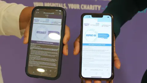 Photo of two phone screens being held by two different people. The screens show a lot of text and descriptions of the two surveys asking people for the views on AI use in healthcare. The left hand screen is primarily dark, while the right hand screen in primarily white. 