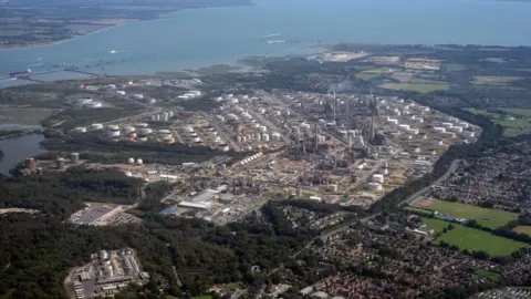 Fawley Refinery and Petrochemical Complex is pictured from the window of an aeroplane, many buildings can be seen and smoke pouring from chimneys at the complex