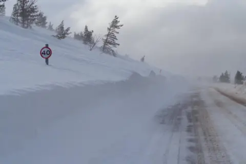 SAIS Northern Cairngorms A 40mph road sign pokes up from a deep snow drift on a high route in the Cairngorms near Aviemore.