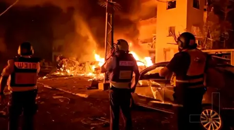 Vehicles set alight following an Iranian missile strike in Haifa