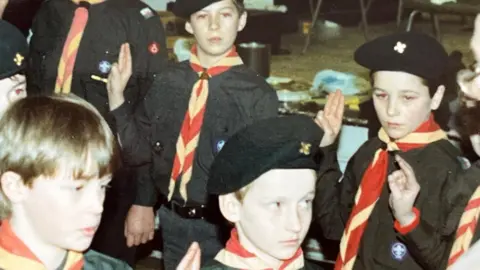 Blundell family P-A (far left) and Rhys (far right) in Scouts together as children wearing Scout outfits