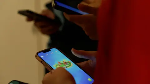 Children play games on smartphones