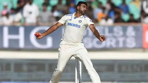 Getty Images India bowler Ravi Ashwin in bowling action after returning after missing day three during day four of the 3rd Test Match between India and England at Saurashtra Cricket Association Stadium on February 18, 2024 