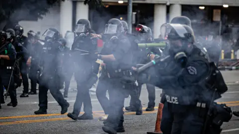 Getty Images LAPD clear the street outside the Metropolitan Detention Center as demonstrators gather in response to ICE raids in Los Angeles on Friday, June 6, 2025 in Los Angeles,