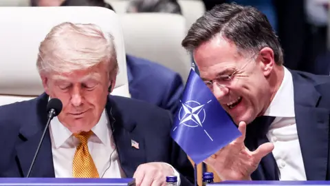 US President Donald Trump jokes with Nato Secretary General Mark Rutte at Nato summit
