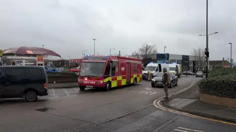 Fire service command vehicle and other emergency service vehicles on the side of a road