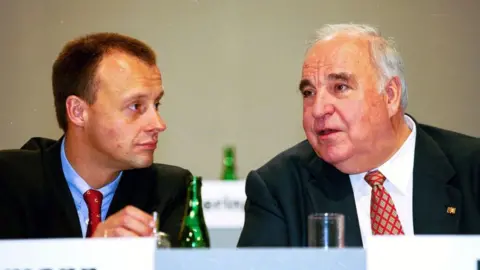 Getty Images Friedrich Merz on a left blue tie listens to the oldest Helmut Kohl Talking 