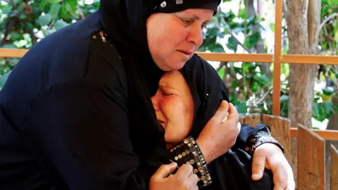 Reuters A Palestinian woman comforts another woman during the funeral for two Palestinians killed in an Israeli drone strike in Rafah, southern Gaza, at Nasser hospital in Khan Younis (3 March 2025)