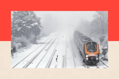 PA A passenger train travels through Worting Junction in Basingstoke, Hampshire in snowy conditions