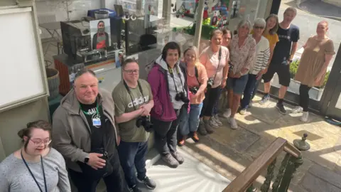 BBC Members of Outside the Box cafe standing with their project 