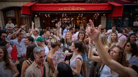 Getty Images Revellers dance in the street during Fete De La Musique 2025 as bands and DJs play on streets across the French capital.
