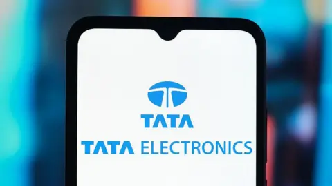 LightRocket via Getty Images Tata Electronics logo is seen displayed on a smartphone screen. 