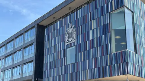 Headquarters of City of Doncaster Council, a modern building with a large coat of arms displayed on the building.