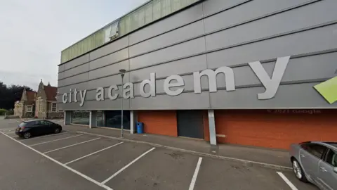 Google image of the outside of City Academy - a building with the silver, metal clad exterior with 'city academy' written in silver letters. 