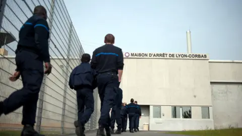 Getty Images Prison staff at Corbas prison attend a press conference on 2 April 2009.