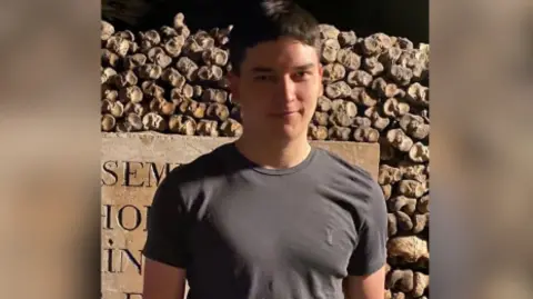 Ormskirk and Rural West Lancs Police Teen boy with dark hair in grey t-shirt, Tom.