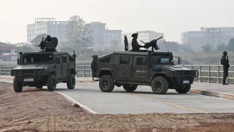 Getty Images Thai military personnel keep watch atop armoured vehicles along the Moei river on the Thai side, next to the 2nd Thai-Myanmar Friendship Bridge, in Thailand's Mae Sot district on April 12, 2024. 