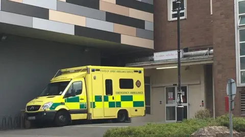 An ambulance parked outside the hospital building.