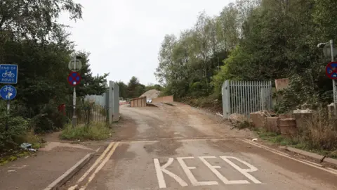 Pete Stonier / SoT Live Metal gates and fencing at the entrance to a quarry