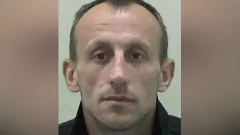 Northumbria Police Mugshot of Danny McGuire. He has a thin face with large ears and balding brown hair