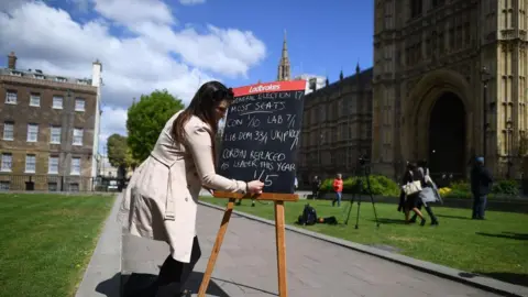 Getty Betting odds for the 2017 general election being written on a blackboard opposite the Houses of Parliament