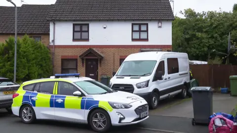 Police and forensic vehicles outside the property in Penylan, Cardiff, at the time of the investigation