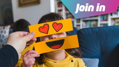 girl holding emoji images above her face, with "join in" gfx on the image