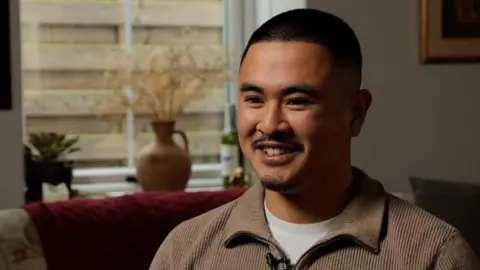 Ike smiling in his living room 