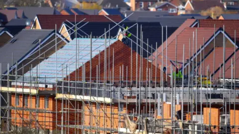 Scaffolding around houses on a building site