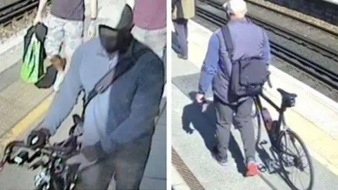 Two images side-by-side. They both show a man in a navy jumper, black trousers and black shoes walking on a train platform with a dark bike. He is wearing a grey hat and a black mask.