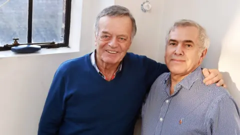 BBC Tony Blackburn pictured in December 2017 in a BBC building with his arm around Phil Swern