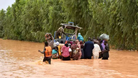 An image of people wading through water in Niger 