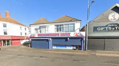 Google Google image of the exterior view of Mablethorpe Ice Cream Company next to a Gifts & Toys shop