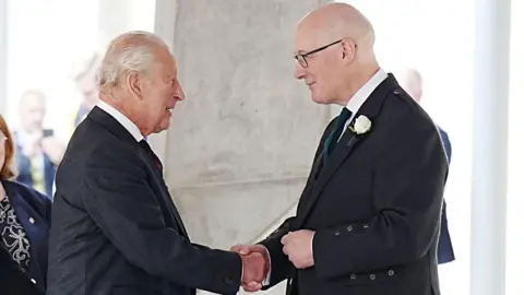 PA Media King Charles greets First Minister John Swinney 