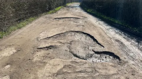 A view of potholes on Aldercar Lane