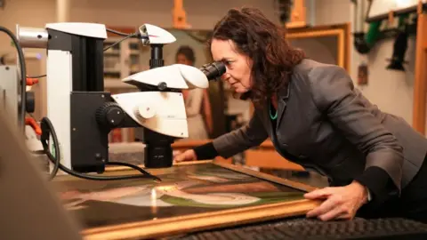 BBC Studios Professor Aviva Burnstock examines a painting for evidence it is by Scottish 18th century artist, Katherine Read.