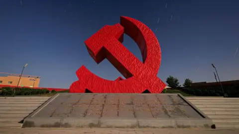 Getty ImagesA sculpture of the symbol of the Chinese Communist Party - the red hammer and sickle. 