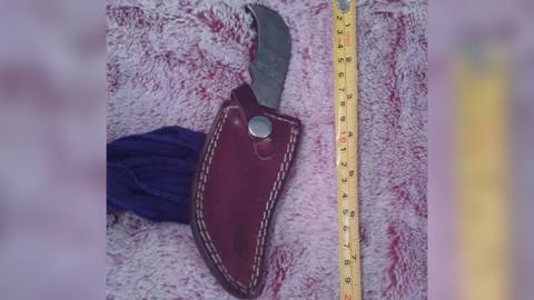 Kirpan next to a tape measure showing it is about 7 inches long