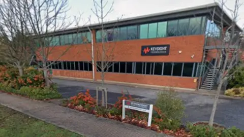 A two-storey brown brick office building on an industrial estate