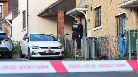 Downsview, Sandown - street of houses with police outside one and tape across the road