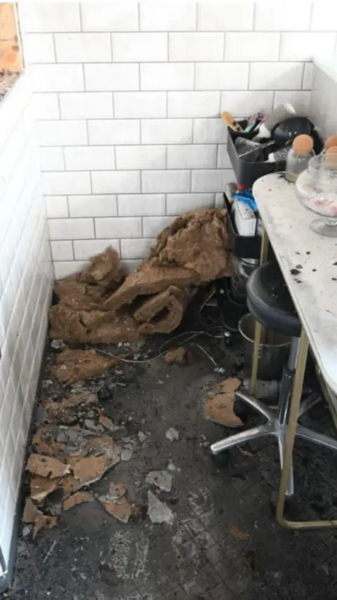 Crown Office fire damage in a small kitchen area