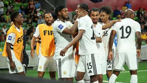 Curacao players celebrate in Kingston after qualifying for the World Cup