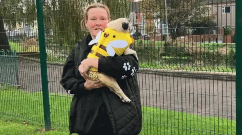 Lara King Sally Brien and her dog Molly standing near the River Freshney in Grimsby