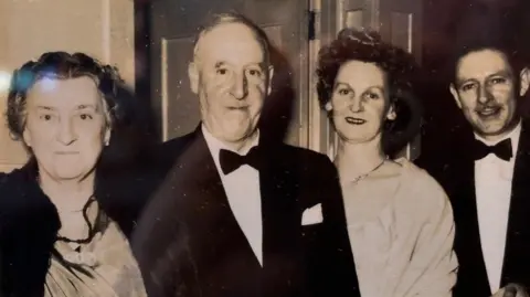 Gareth Cammack Taken in the late 1950s, the image shows founder Billy Jackson, in a tuxedo, with other family members
