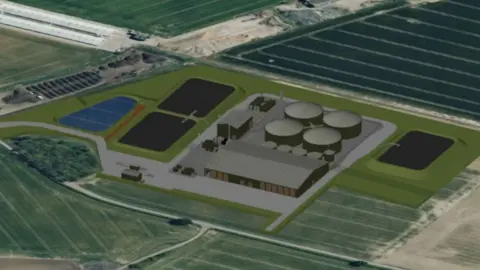 The image shows a computer‑generated aerial view of an energy facility set within a large, flat agricultural landscape. At the centre of the site are several large circular tanks, connected by roads and surrounded by industrial buildings.