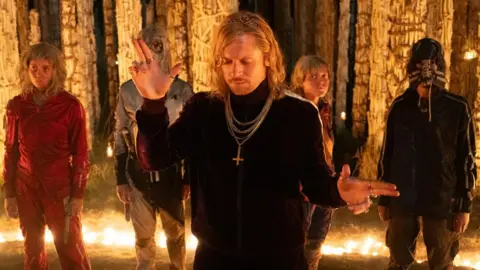 Erin Kellyman, wearing red, and Jack O'Connell, centre, in 28 Years Later: The Bone Temple 